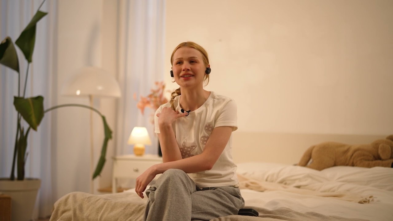 Thea, a student, wearing BeCozU earpieces in her bedroom